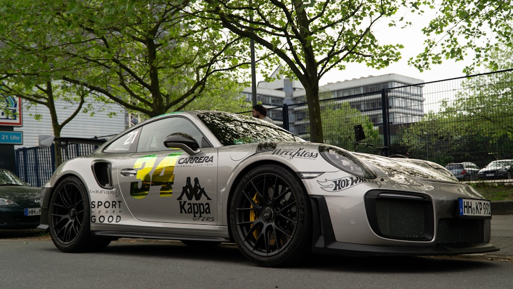 a silver sports car parked on the side of the road