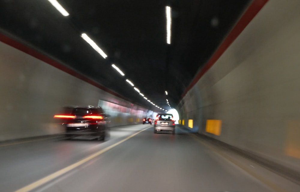 a blurry photo of cars driving in a tunnel