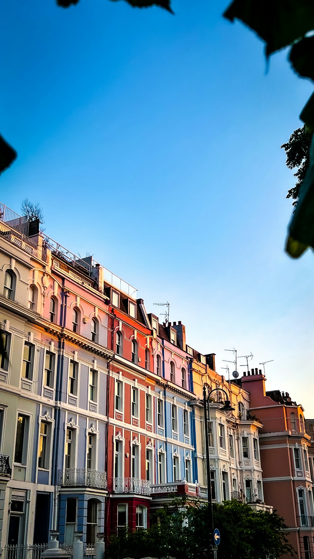 a row of multi - colored buildings with a blue sky in the background