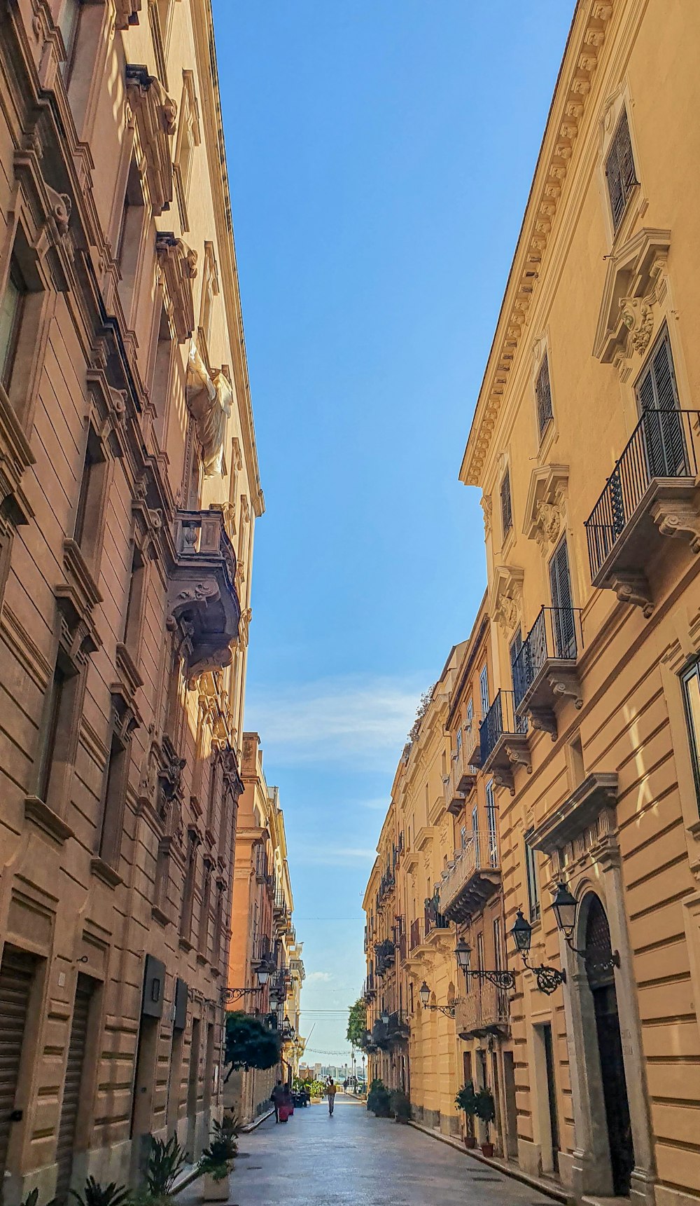 a narrow city street lined with tall buildings