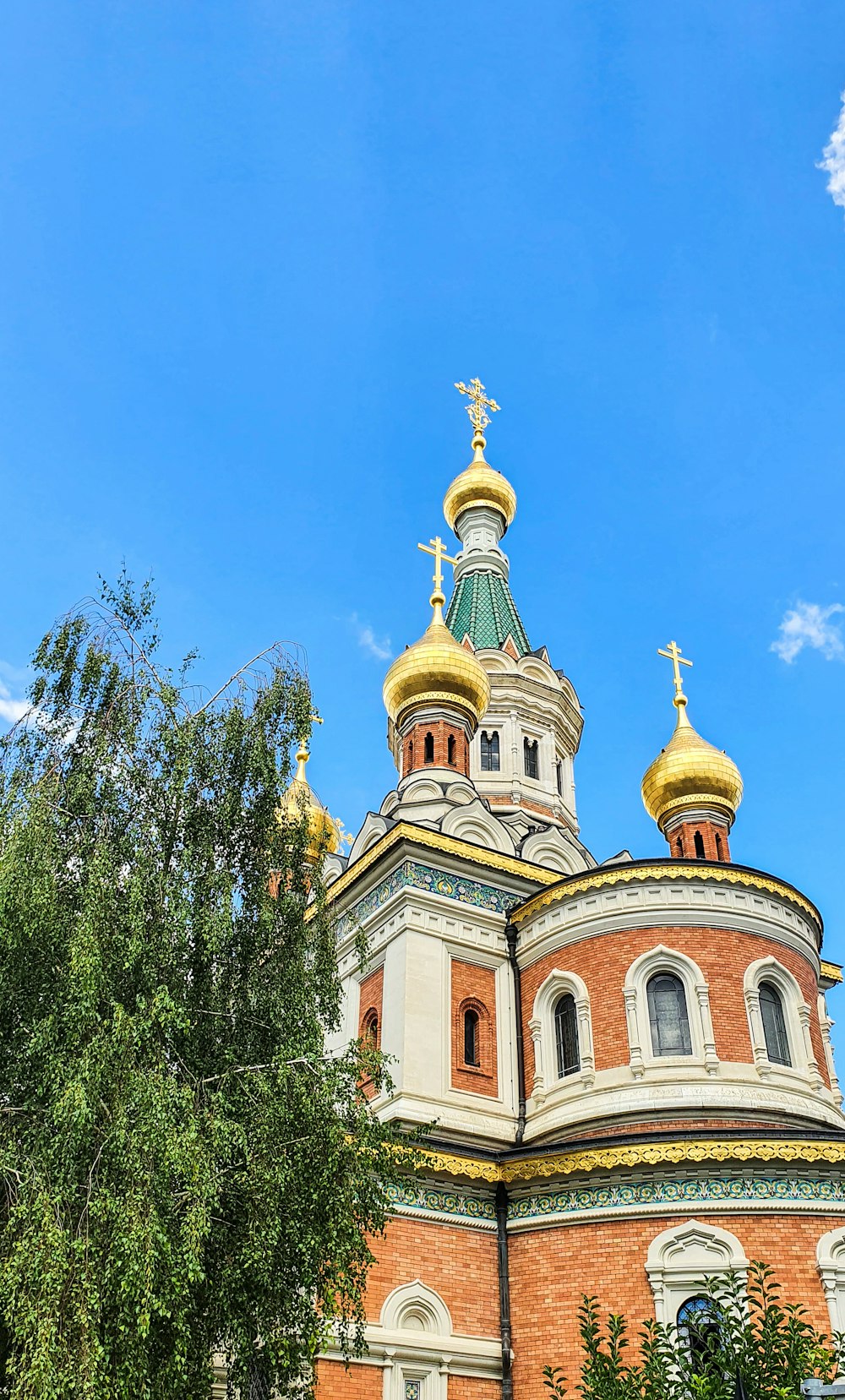 a large building with a golden roof and a cross on the top of it