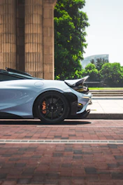a white sports car parked in front of a building