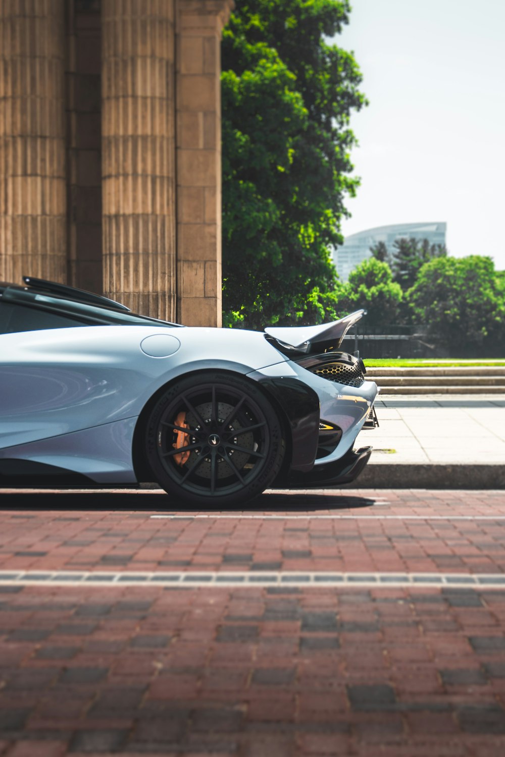 a white sports car parked in front of a building