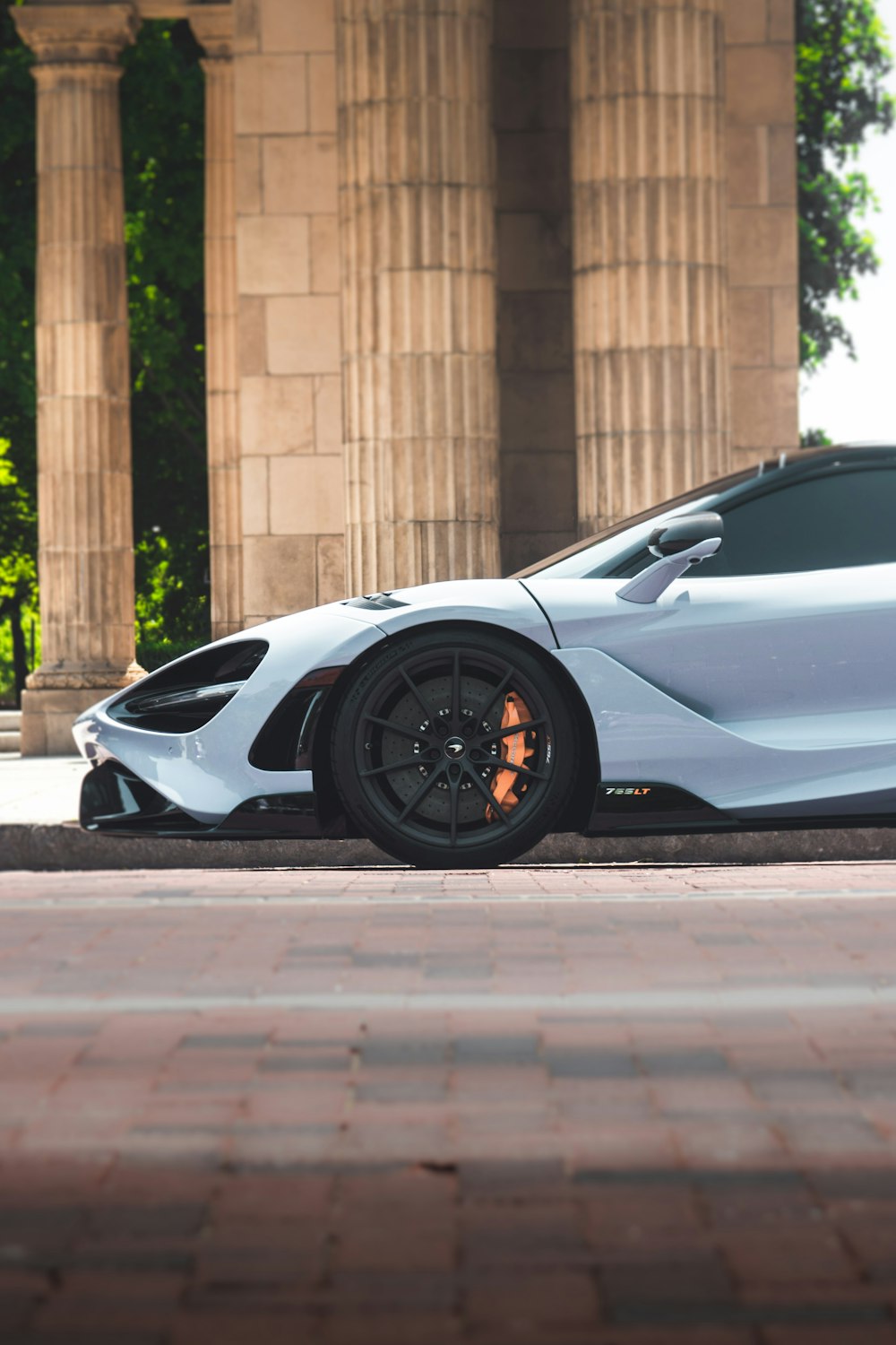 a white sports car parked in front of a building