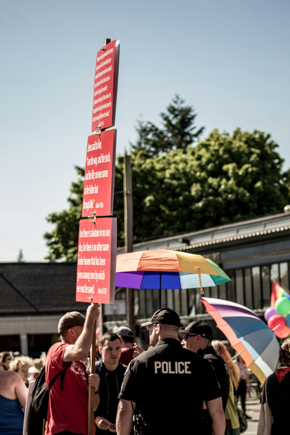 a group of people holding up signs and umbrellas