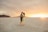 a couple embracing in the desert at sunset