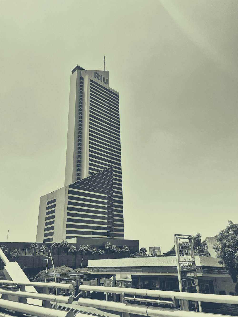 a very tall building sitting next to a bridge