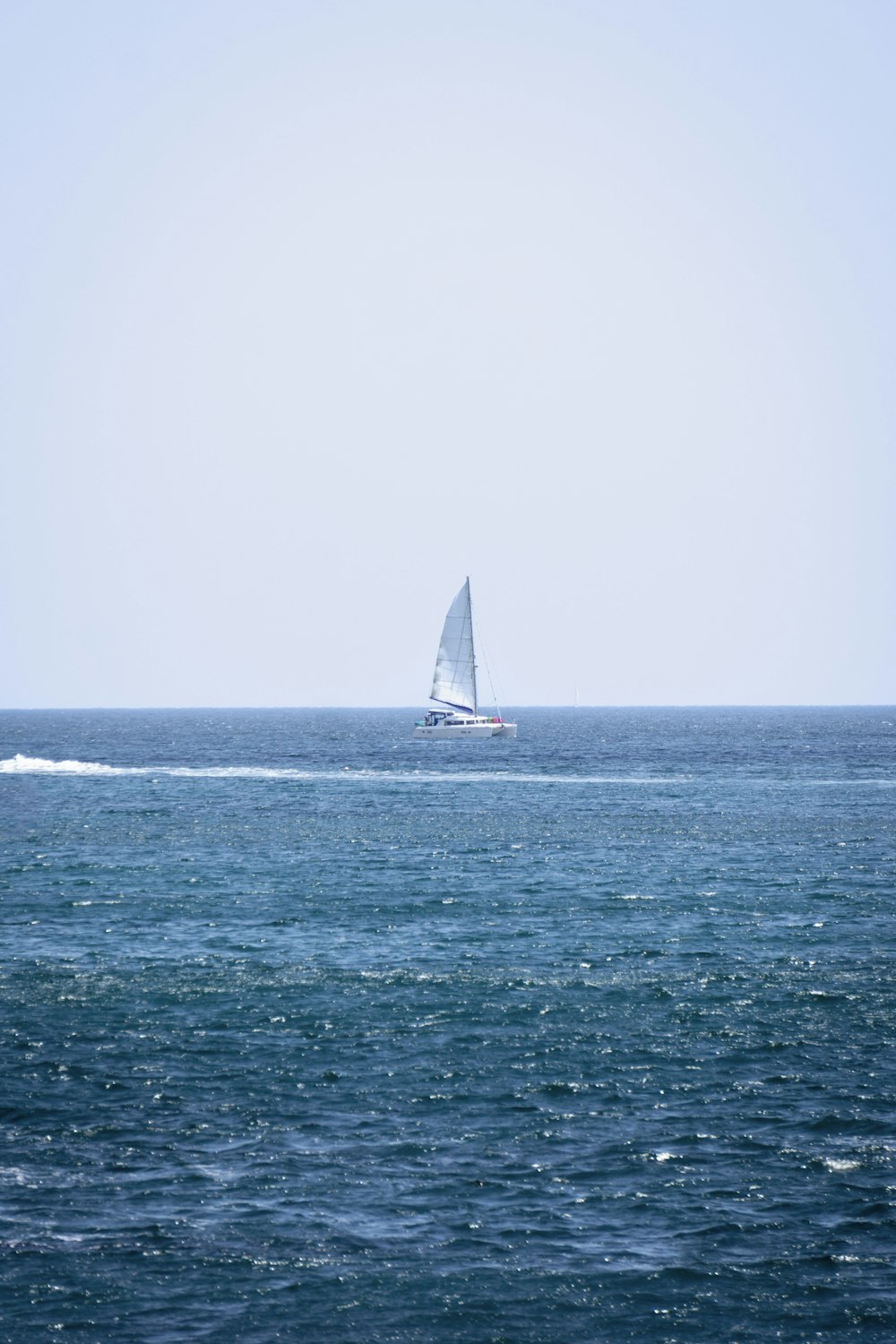 a sailboat in the middle of the ocean