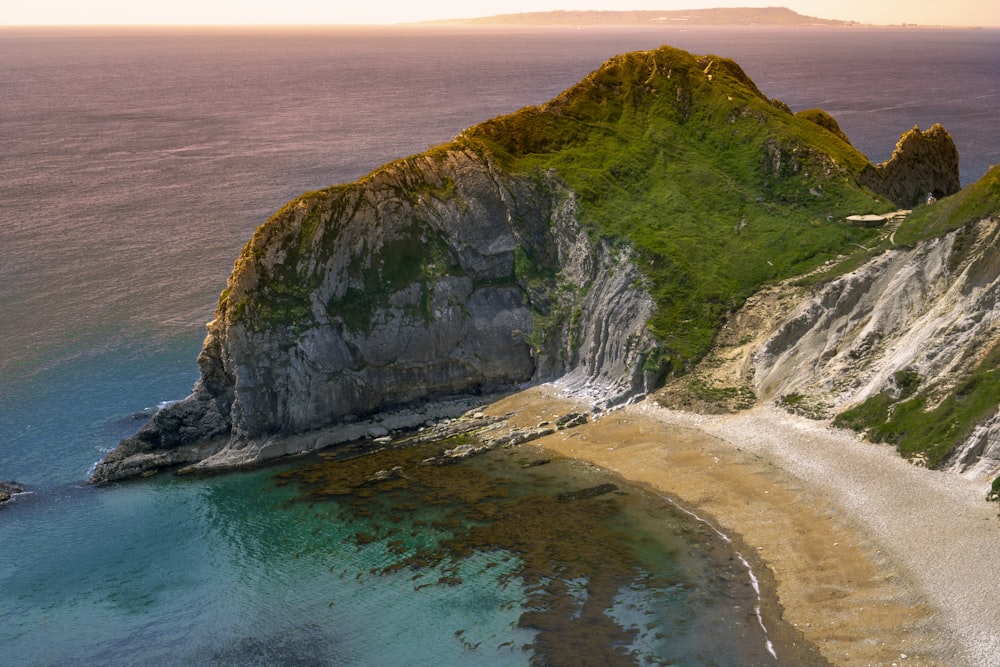 an aerial view of an island with a sandy beach