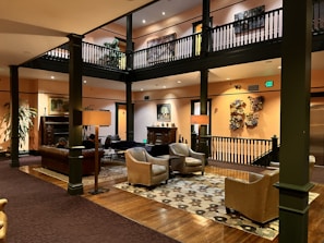 Designer lobby seating with plush accent chairs and modern coffee tables in a welcoming hotel entrance.