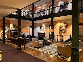 Cozy hotel lobby featuring comfortable seating and warm lighting, inviting guests to relax.