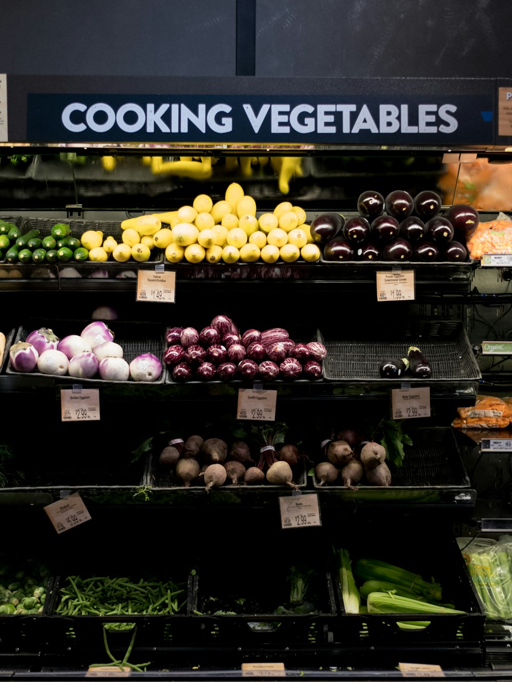 a produce section of a grocery store filled with fruits and vegetables