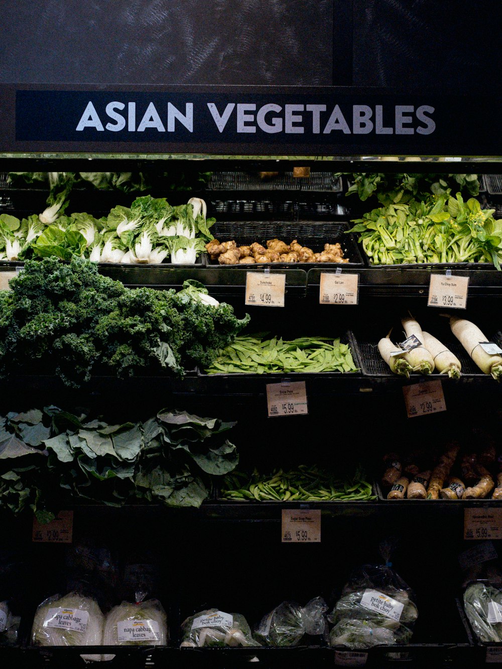 a produce section of a grocery store filled with vegetables