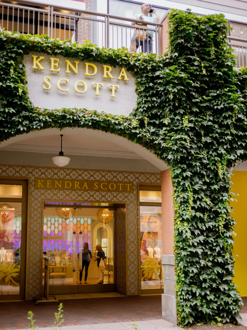 the entrance to a store with ivy growing on it