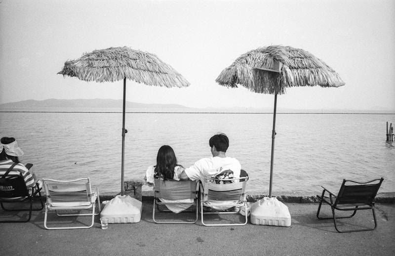 Couple relaxing under beach umbrellas