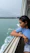 Smiling woman enjoying a boat tour with turquoise sea in the background