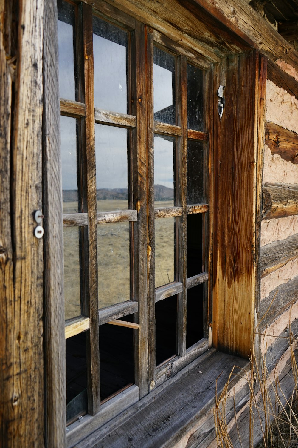 a window on the side of a log cabin