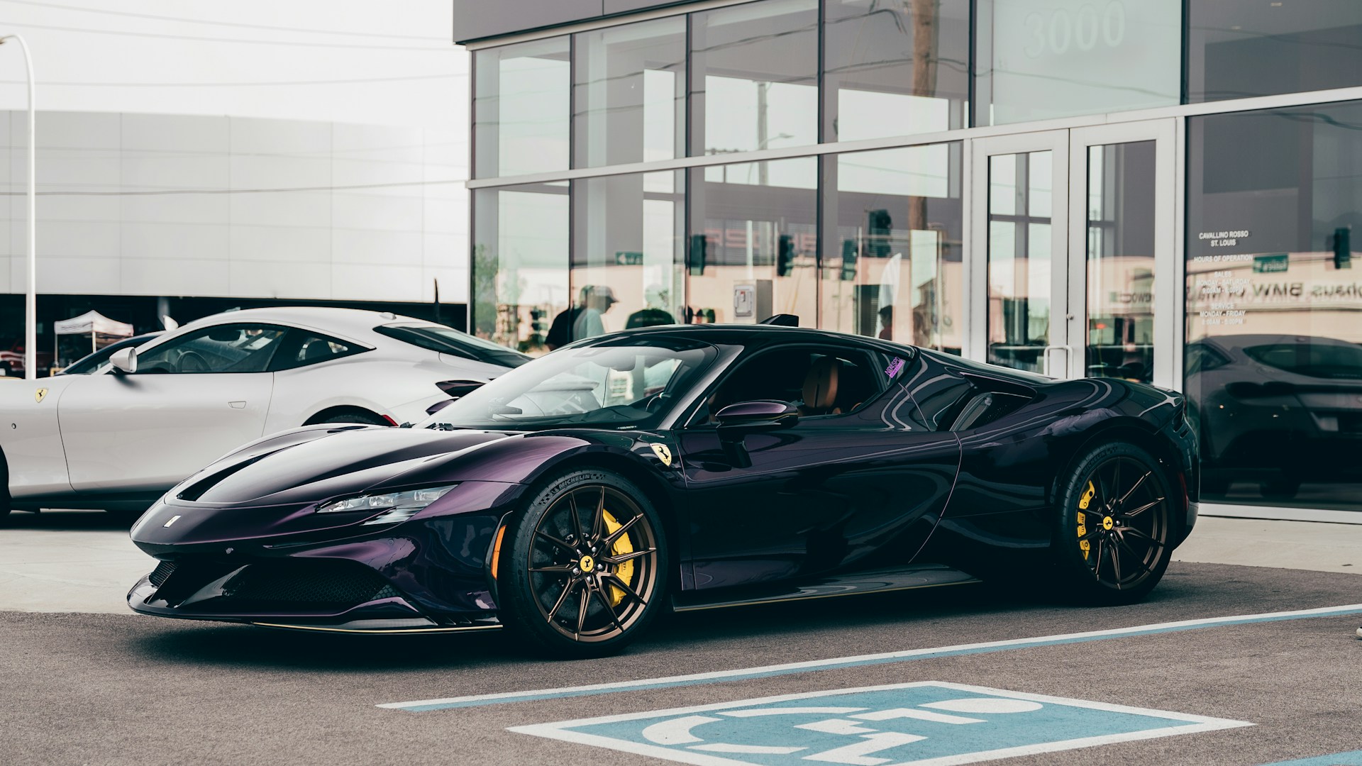 a purple sports car parked in front of a building
