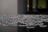 Close-up of colorful puzzle pieces fitting together on a wooden table.
