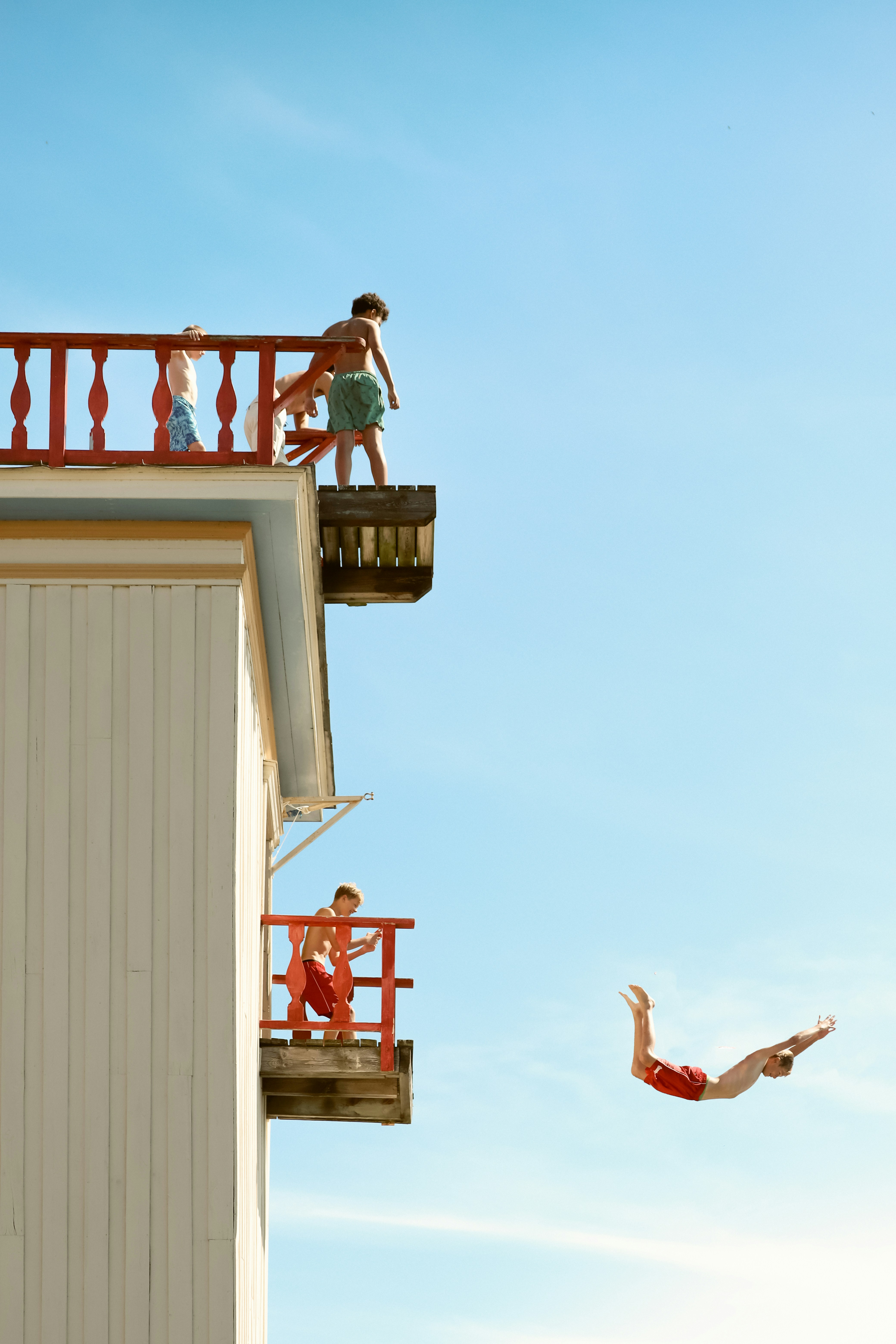 a person jumping into the air from a building