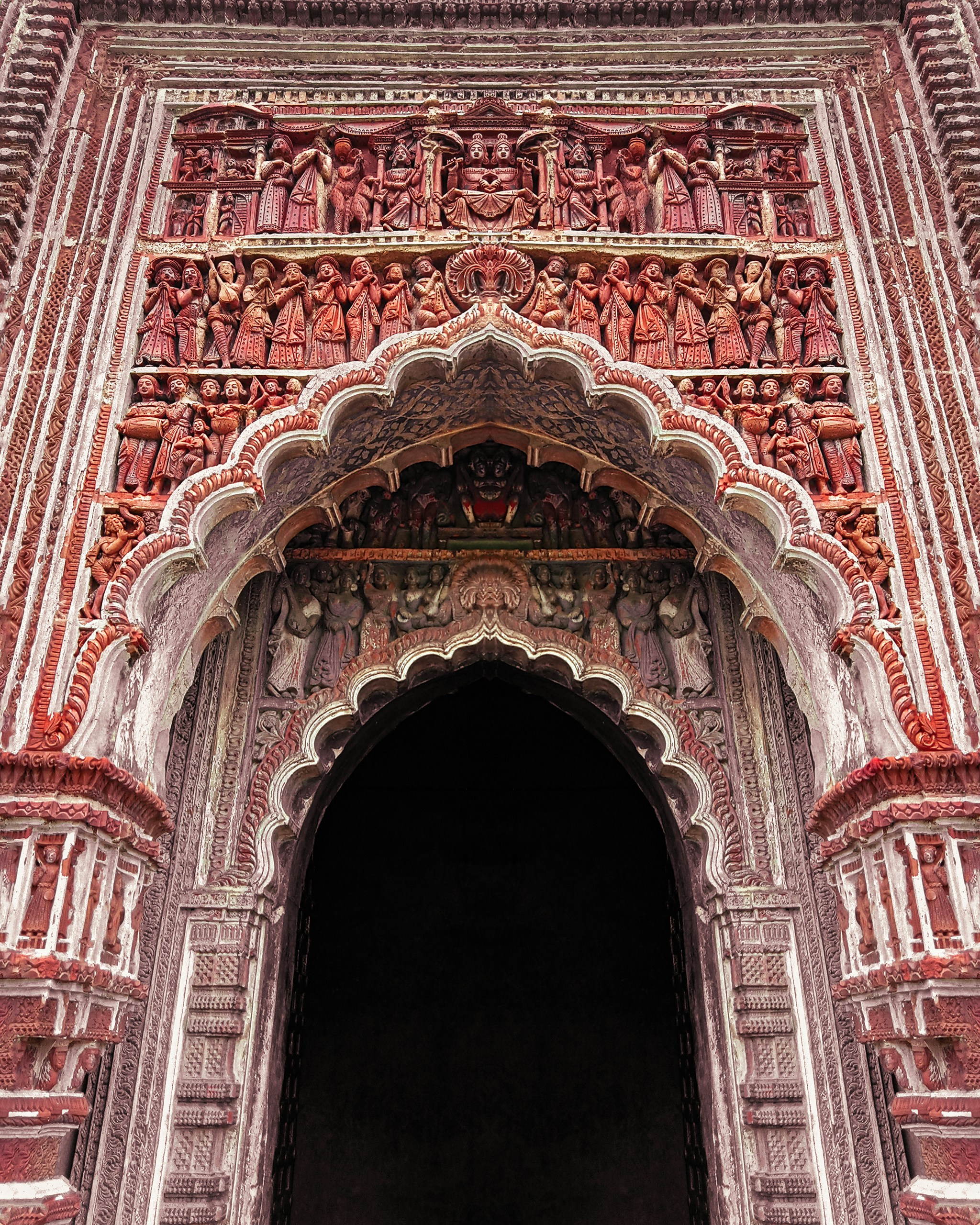 a large ornate doorway with a clock on it's side