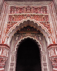 a large ornate doorway with a clock on it's side