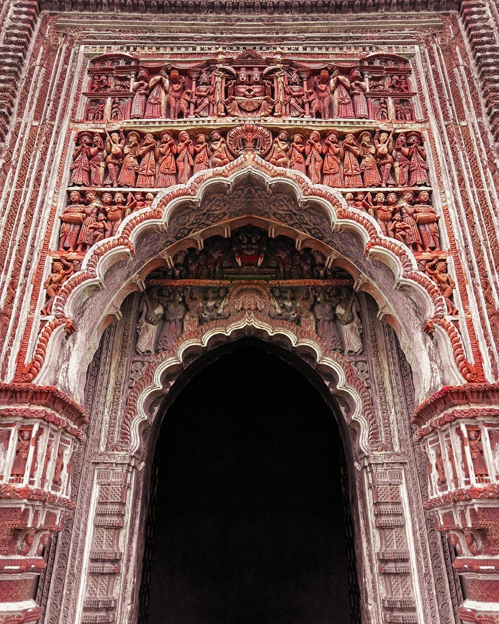 a large ornate doorway with a clock on it's side