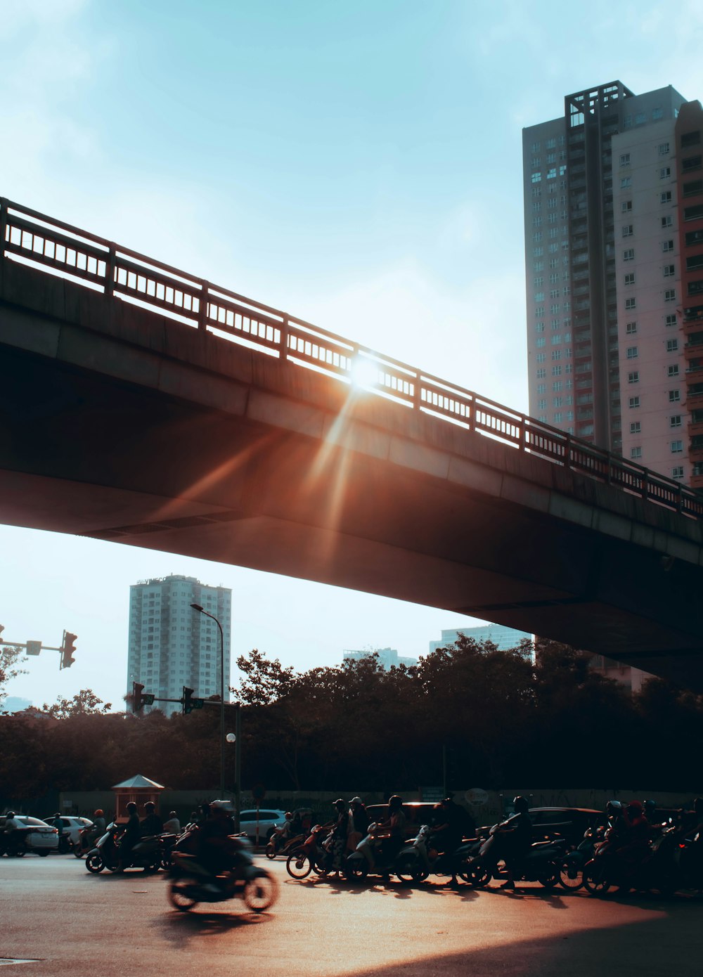 a group of motorcycles parked under a bridge