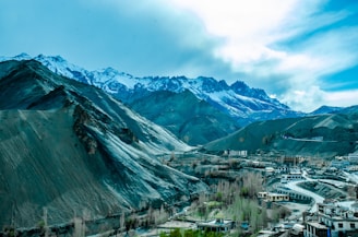 A panoramic view of the Andes mountains with a traditional village nestled in the valley.