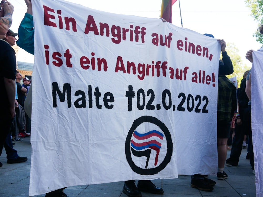 a group of people holding up a banner