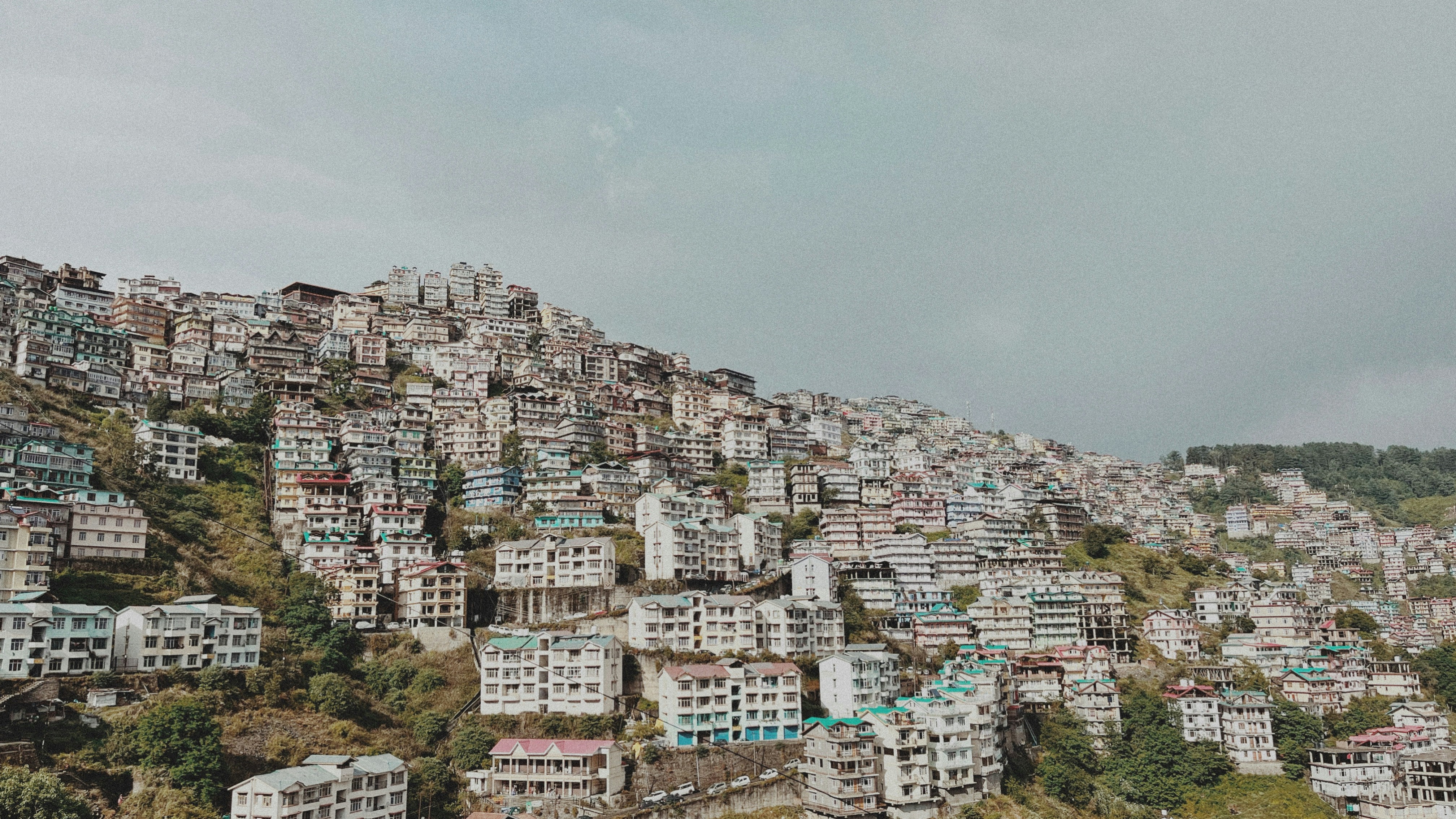 a large group of buildings sitting on top of a hill