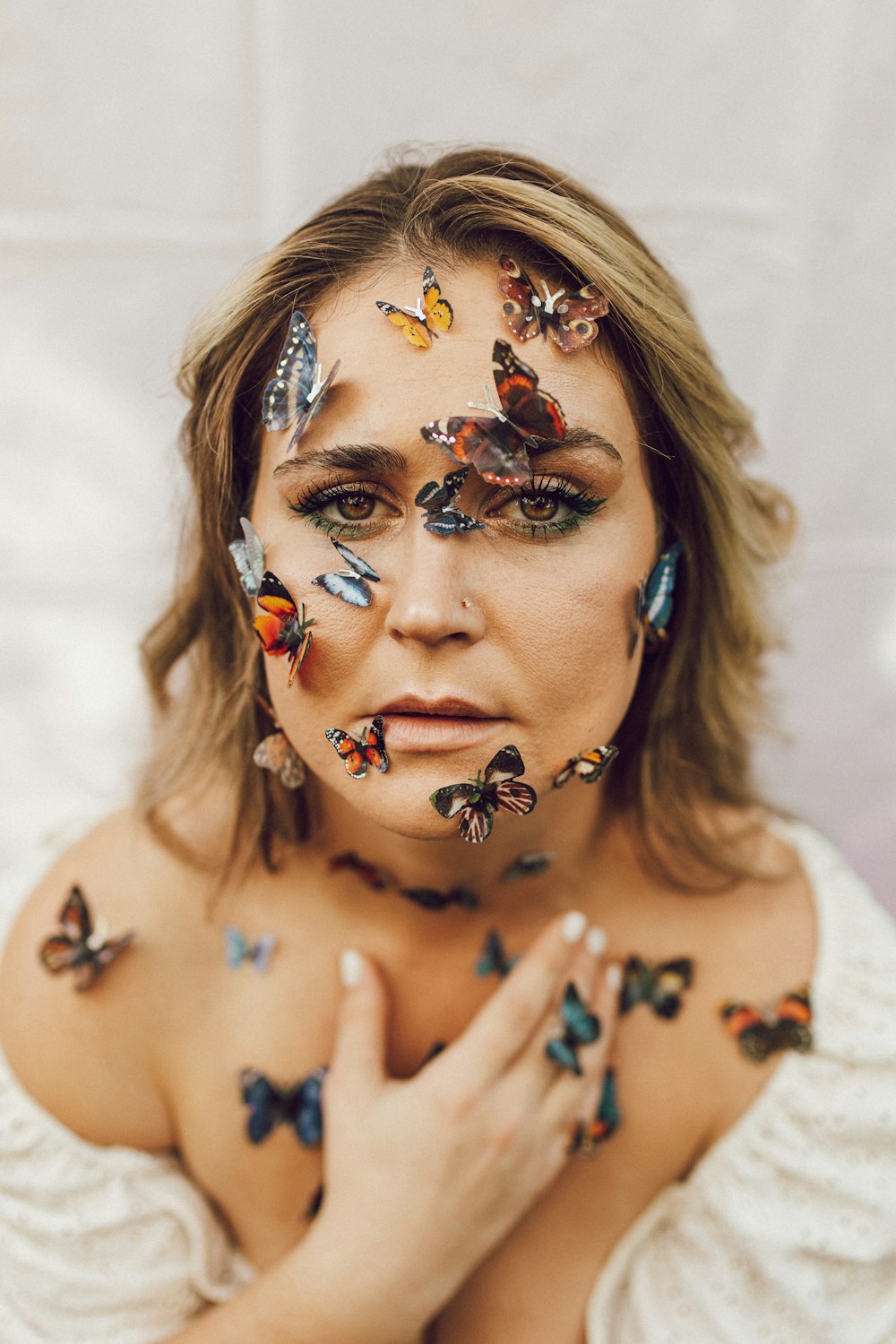 a woman with butterflies painted on her face