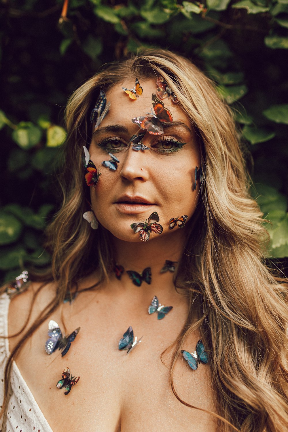 a woman with butterflies painted on her face