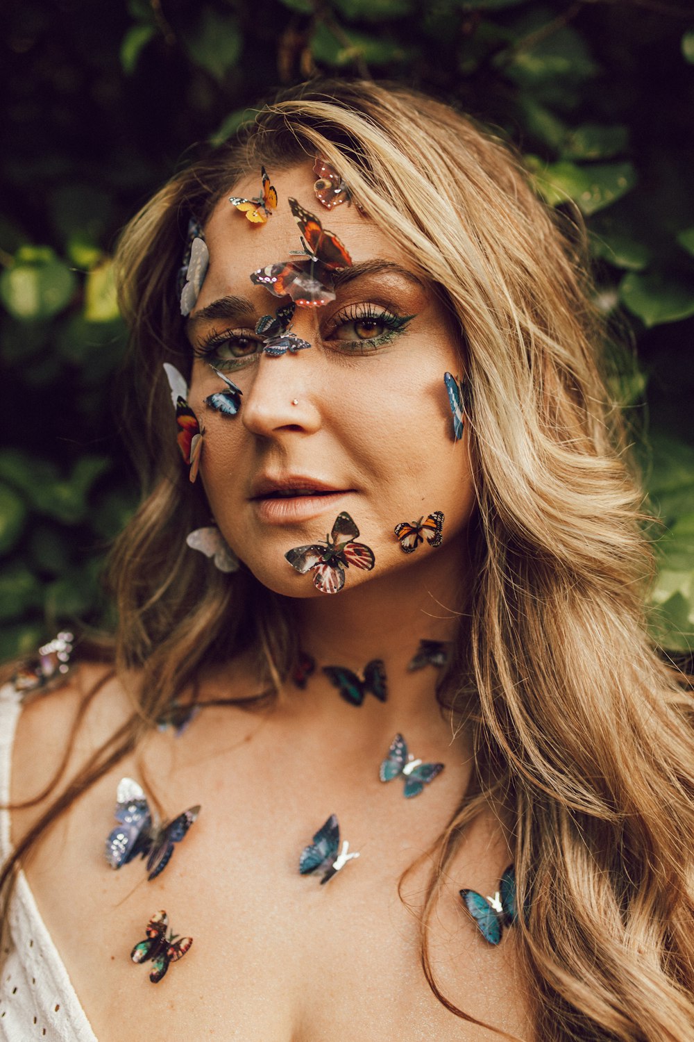 a woman with butterflies painted on her face