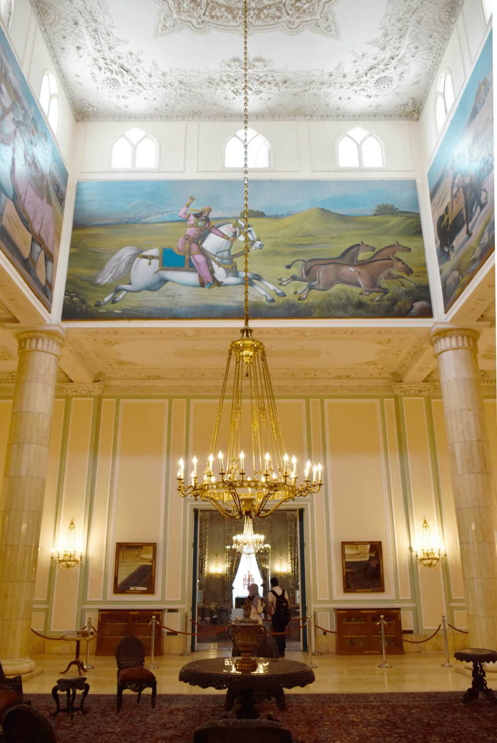 a chandelier hanging from the ceiling of a large room