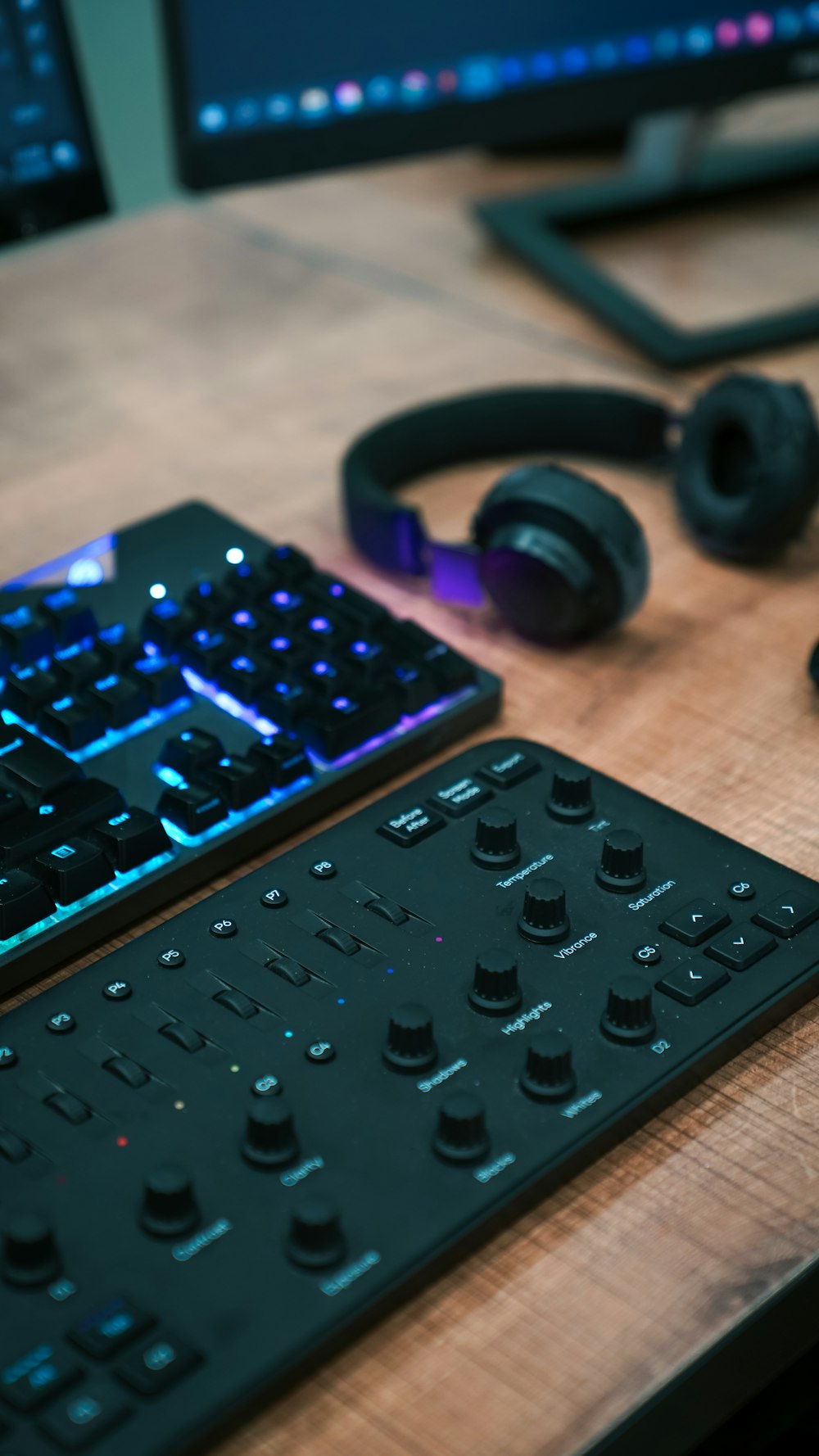 a keyboard, mouse, and headphones sitting on a desk