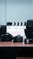 a table with a camera and a movie clapper