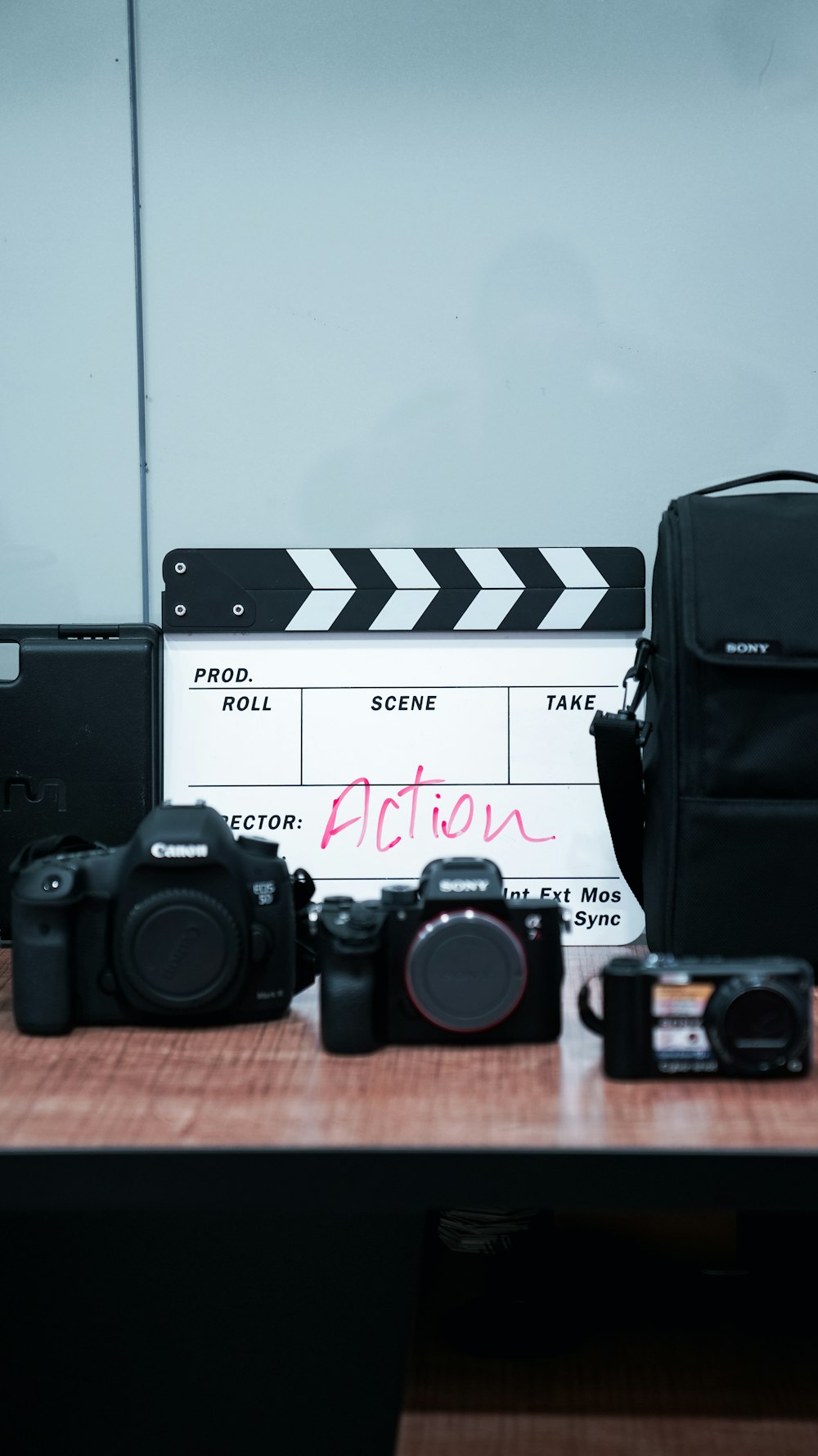 a table with a camera and a movie clapper