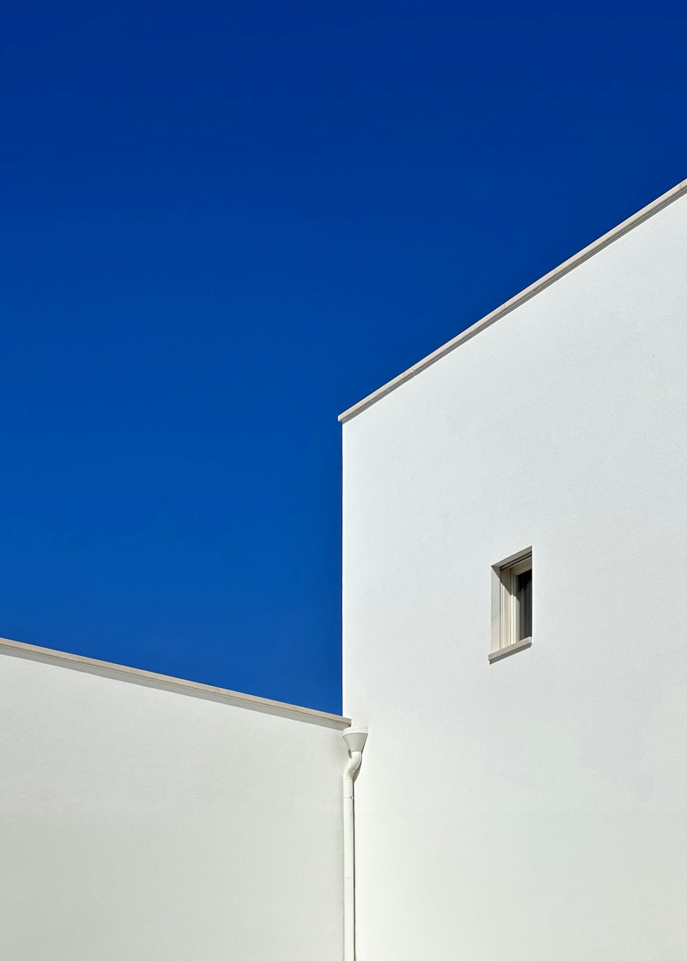 a white building with a blue sky in the background