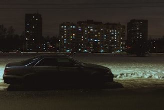A car parked safely on a quiet street, representing auto insurance security.