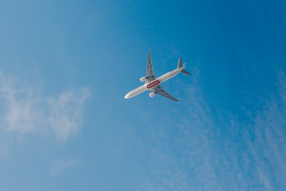 an airplane is flying in the blue sky