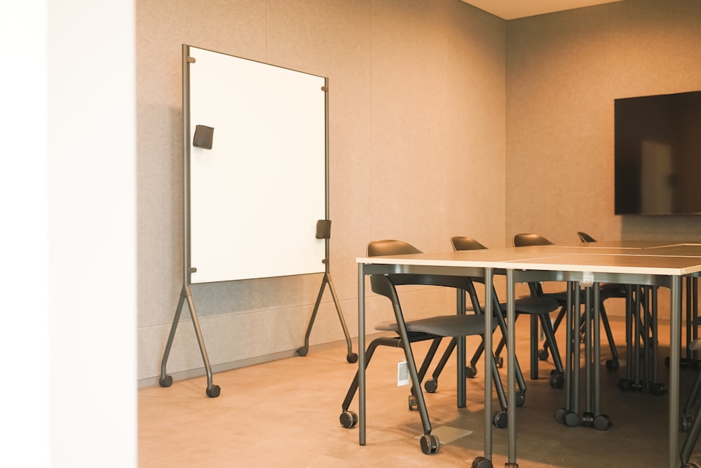 a conference room with a whiteboard and chairs