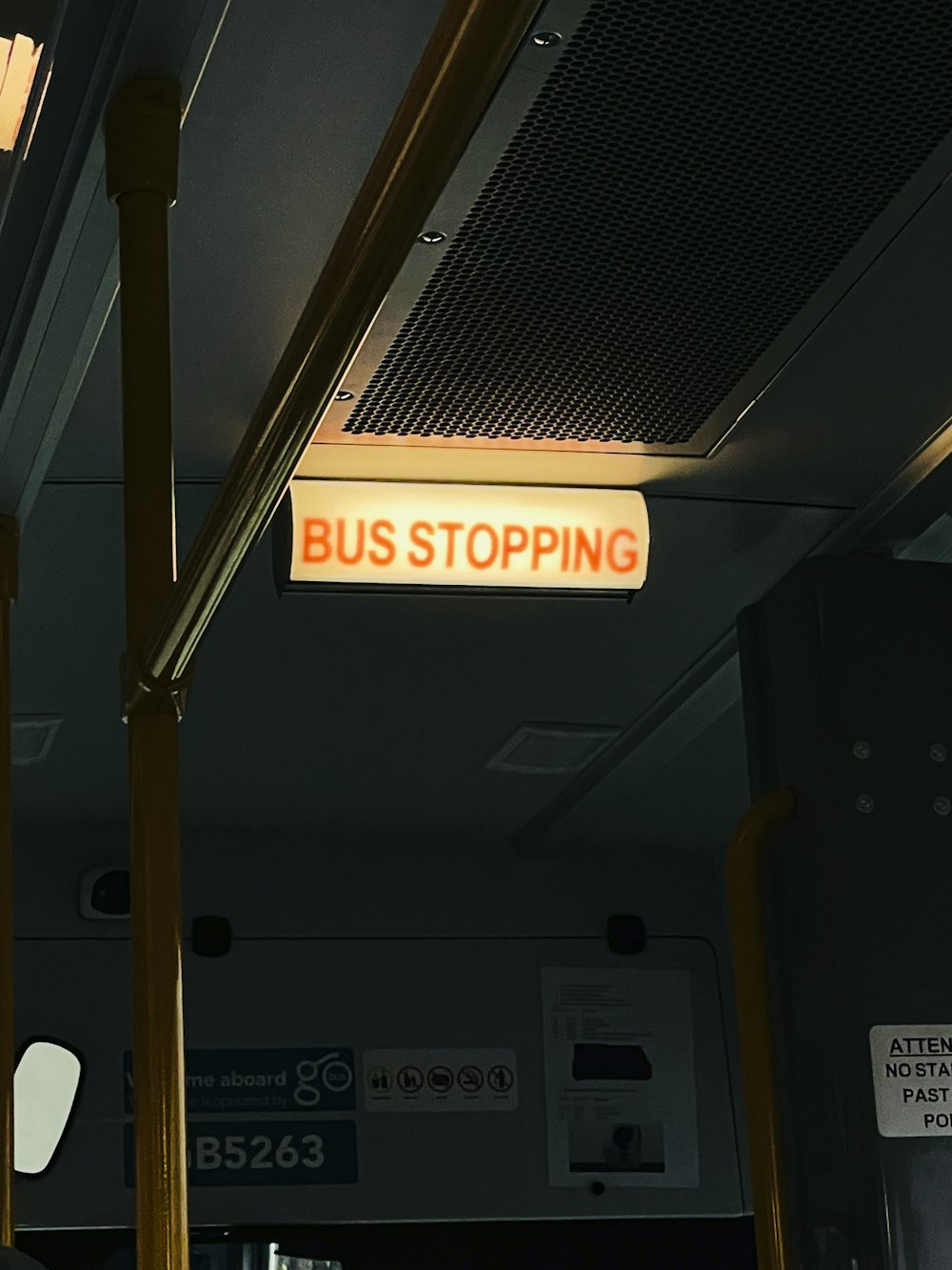 a bus stop sign hanging from the ceiling