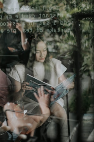 A serene setting featuring a woman reading a fashion magazine.