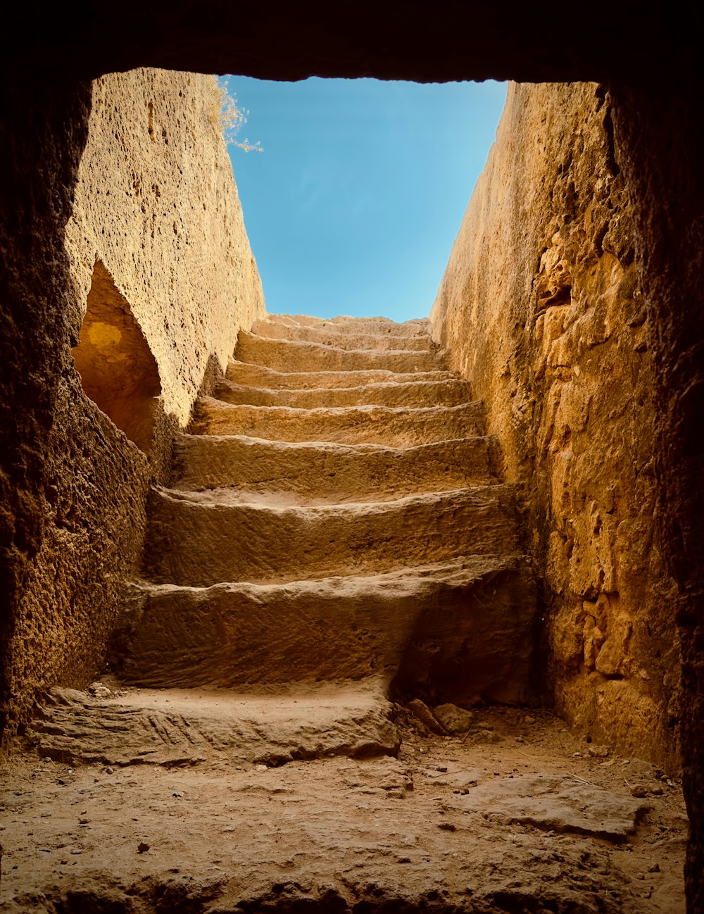 a set of stone steps leading up to a blue sky