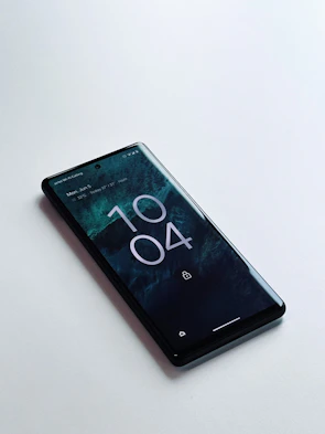 Samsung Galaxy J7 lock screen displaying a sleek dark wallpaper with subtle light accents.