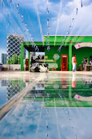 A sleek 360 videobooth setup glowing softly at a lively outdoor evening party