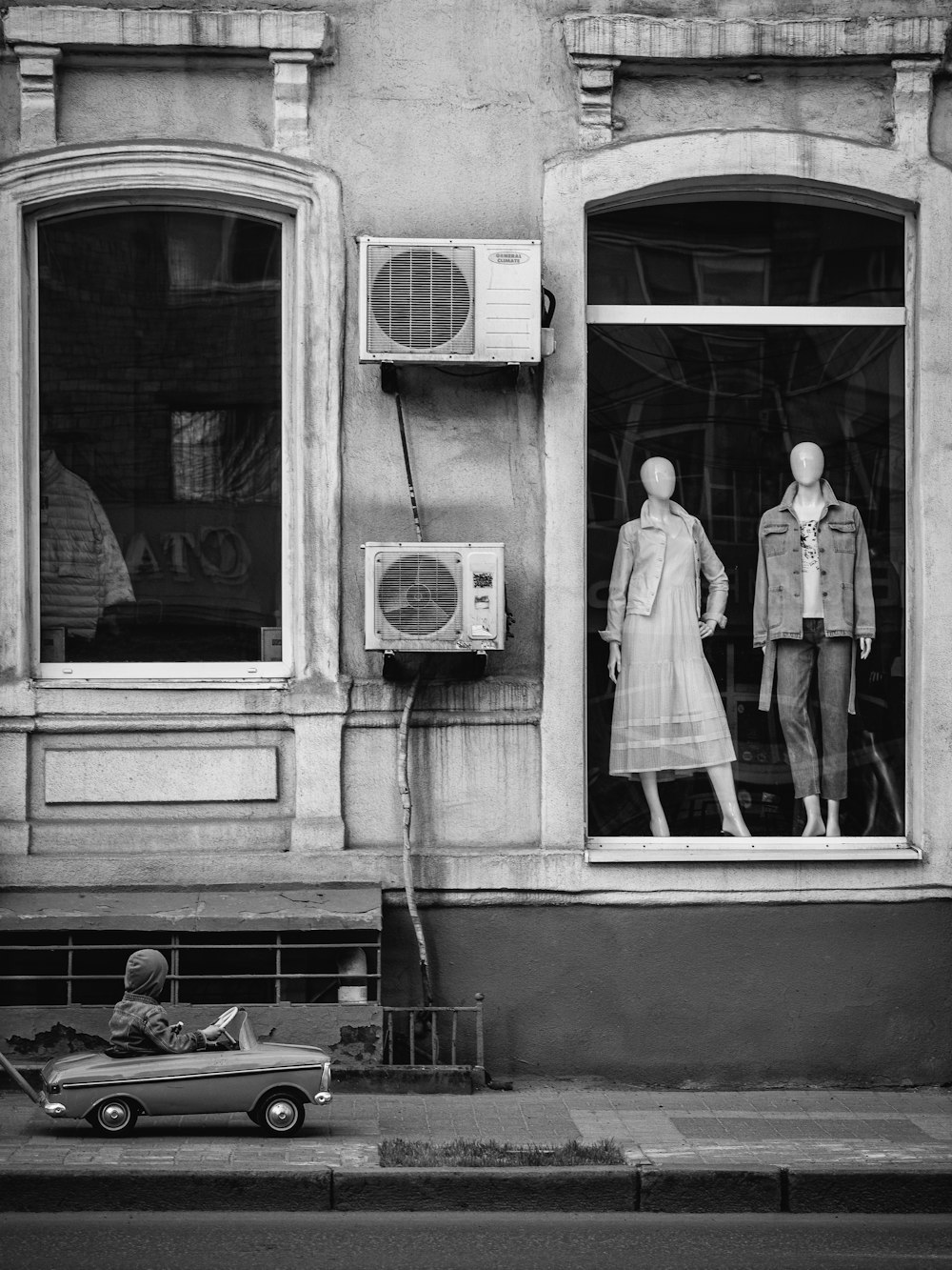 a couple of mannequins are in a window