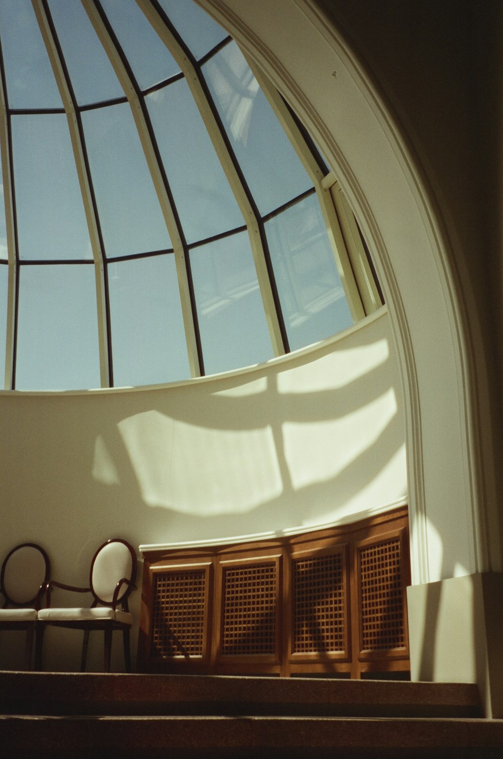 a room with a large window and a chair