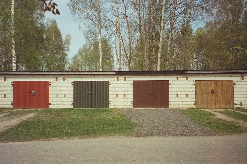 a row of garage doors in front of a brick building